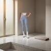 A woman wearing light blue high-waisted tight pants paired with white long socks and sports shoes can make her legs look longer Application Scenario
